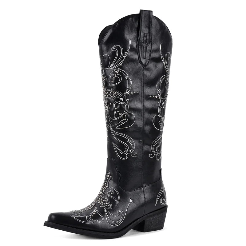 Black cowboy boot with intricate white embroidery on a white background