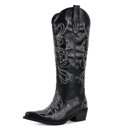 Black cowboy boot with intricate white embroidery on a white background