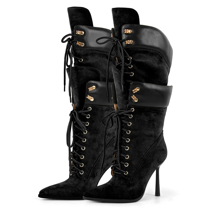 Black suede knee-high boots with gold accents on a white background