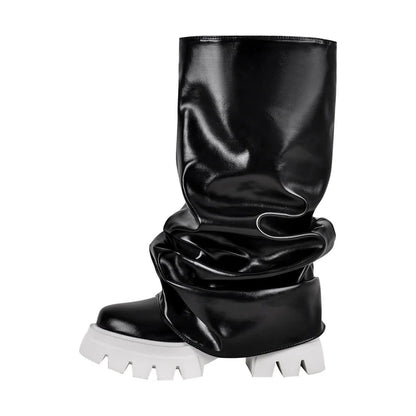 Black glossy knee-high boot with white sole on a white background