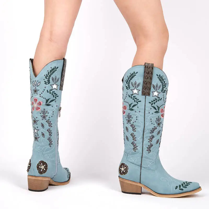 Light blue embroidered cowboy boots on a white background