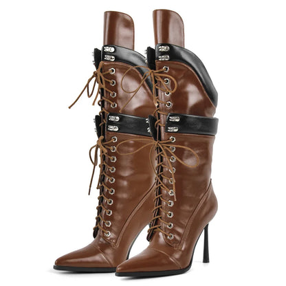 Brown high-heeled boots with black straps and laces on a white background