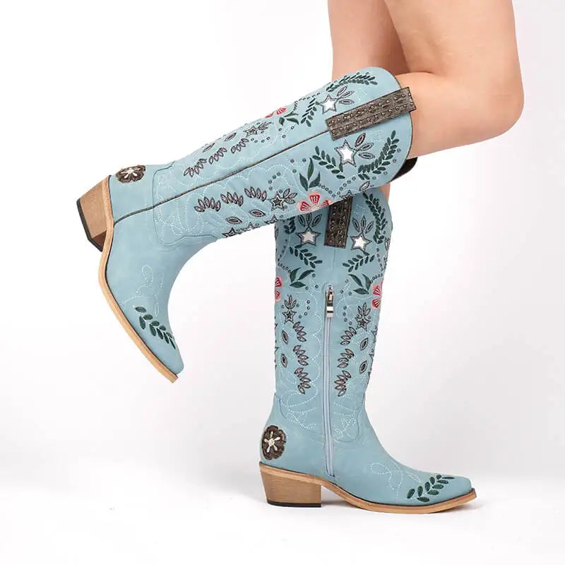 Light blue embroidered boots on a white background