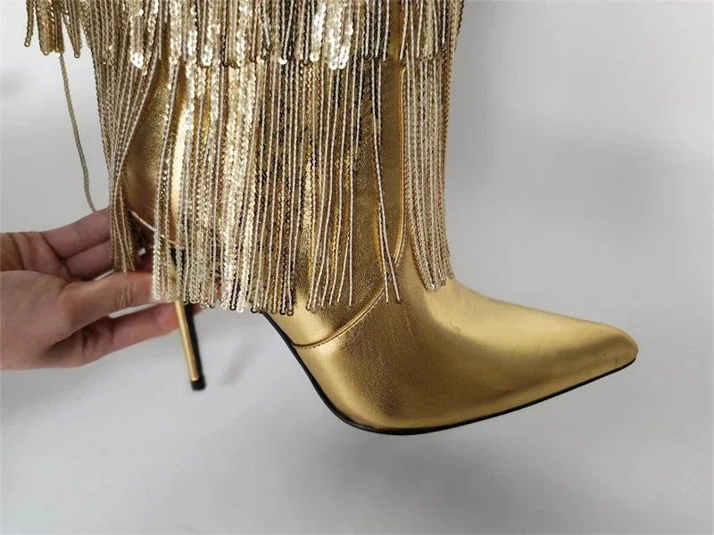 Gold fringe high-heeled boots on a light gray background