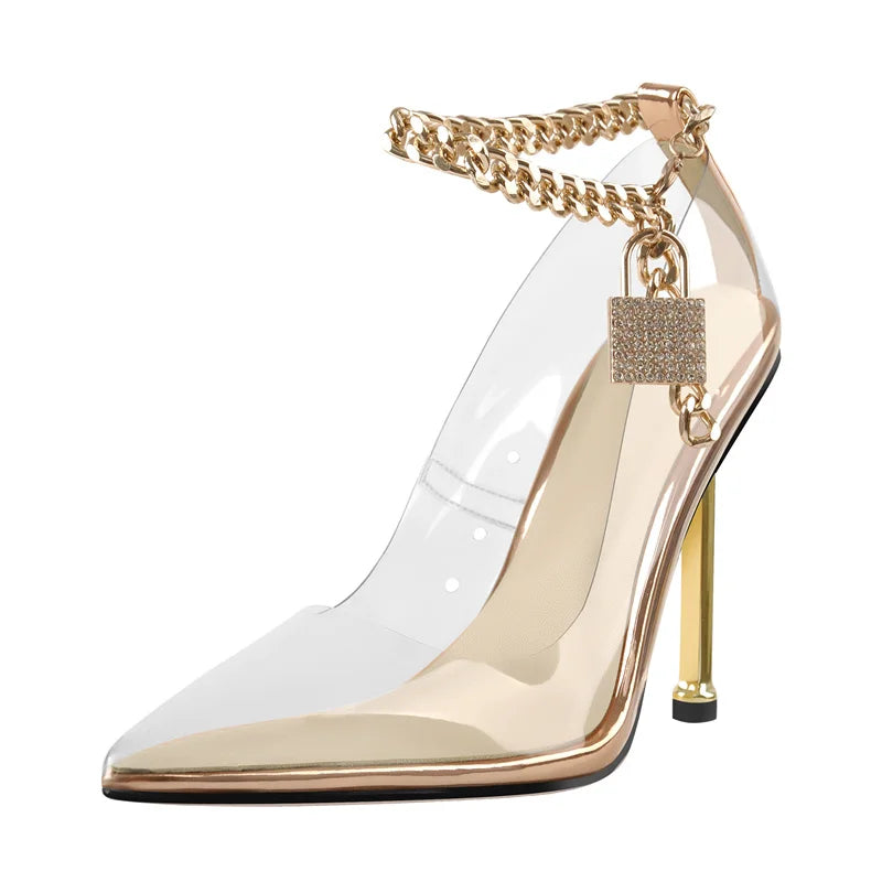 Gold high-heeled shoe with clear transparent sole and chain detail on a white background