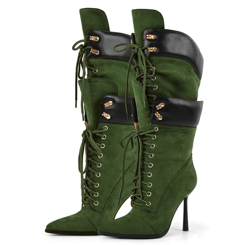 Green high-heeled boots with black accents on a white background