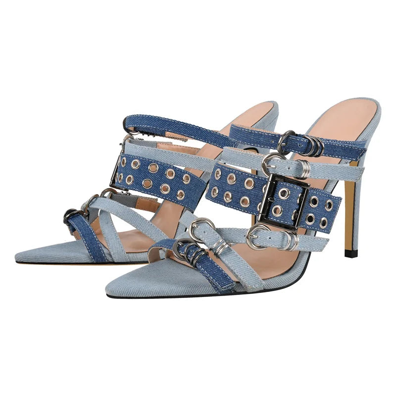 Blue high-heeled shoes with strap details on a white background