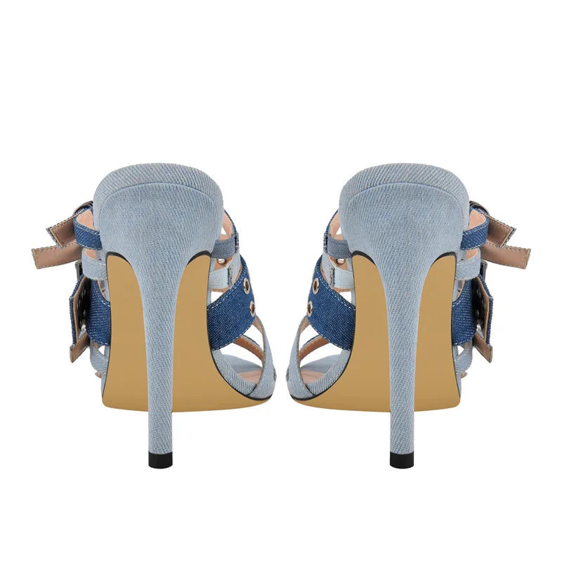 Pair of high-heeled shoes with denim straps on a white background
