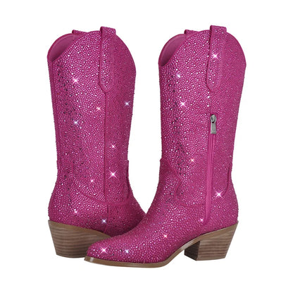 Pink glittery cowboy boots with brown soles on a white background