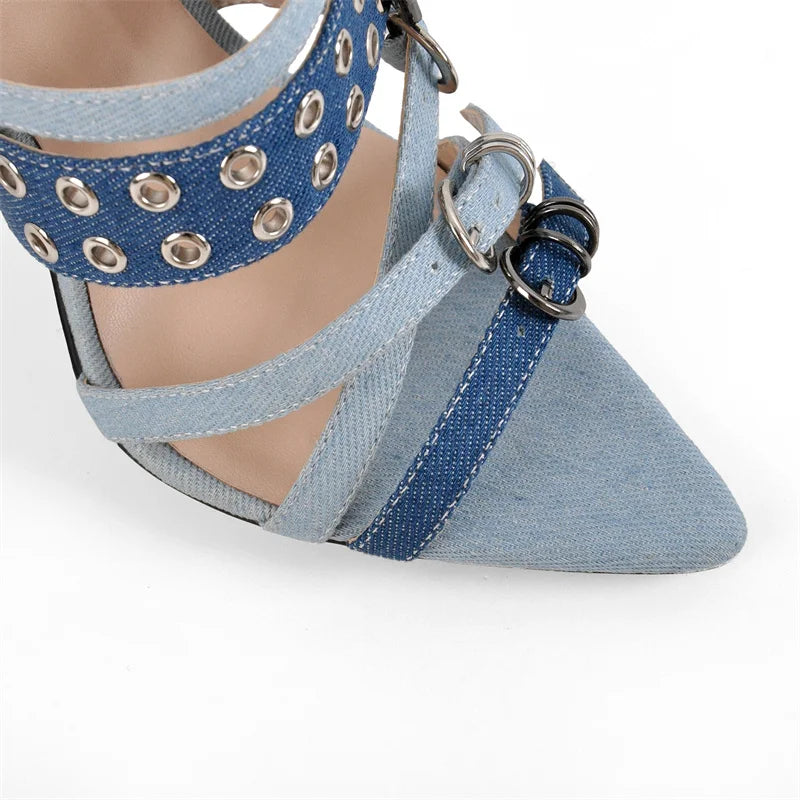 Blue denim shoe with metal eyelets on a white background