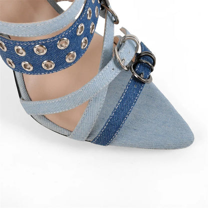 Blue denim shoe with metal eyelets on a white background