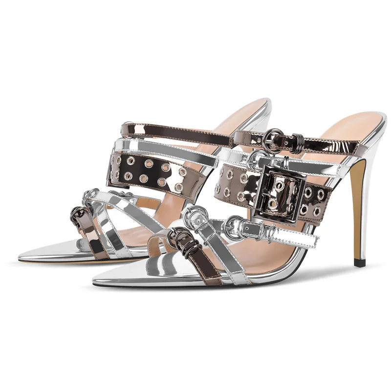 Silver high-heeled sandals with decorative straps on a white background