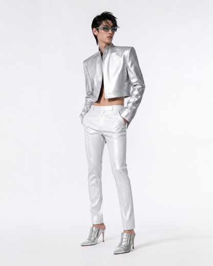 Person wearing a silver jacket and pants with high heels on a white background