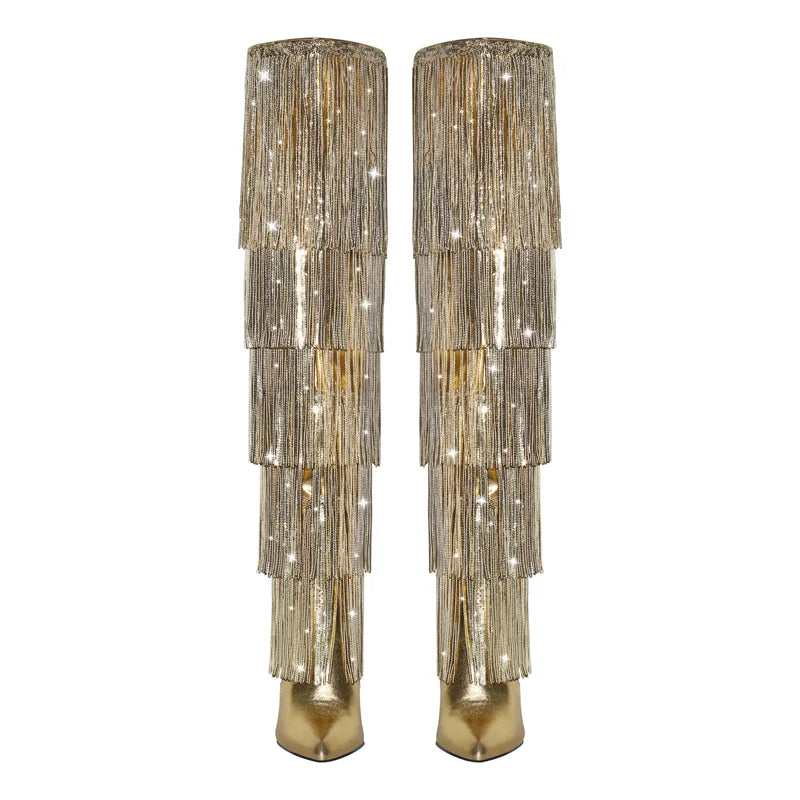 Pair of gold beaded boots on a white background