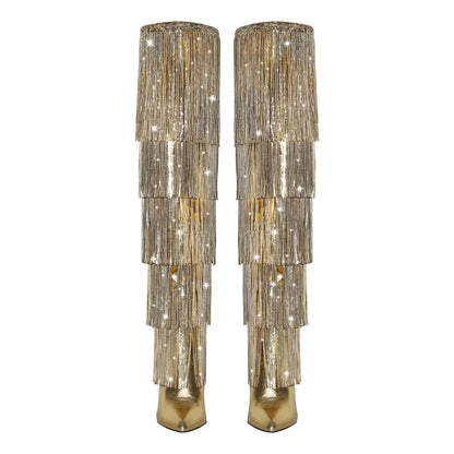 Pair of gold beaded boots on a white background