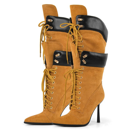 Tan high-heeled boots with black accents and gold laces on a white background